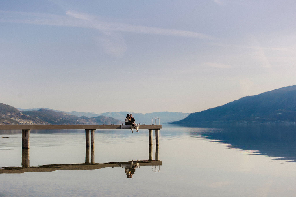 Kelowna engagement photographer session on a dock by the okanagan lake