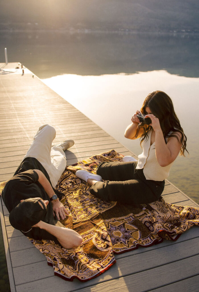 Kelowna engagement photographer session on a dock by the okanagan lake