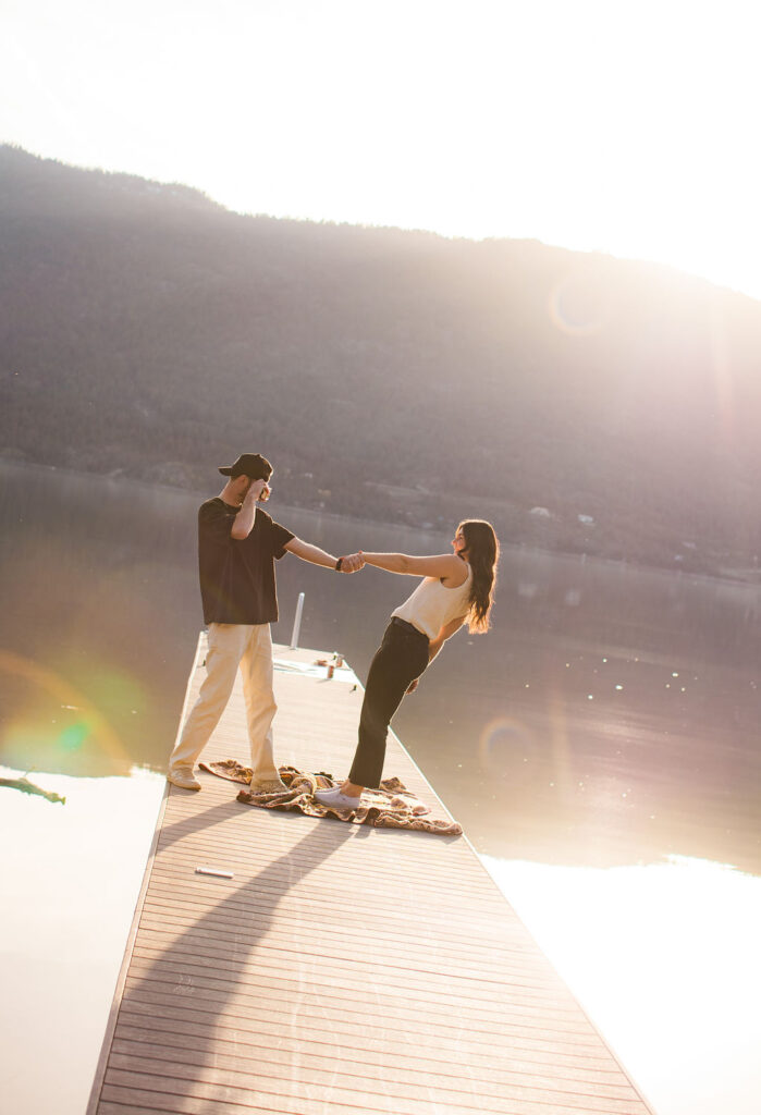Kelowna engagement photographer session on a dock by the okanagan lake