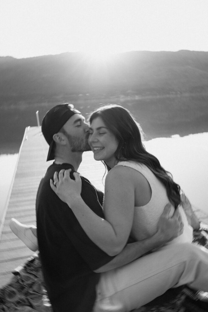 Kelowna engagement photographer session on a dock by the okanagan lake