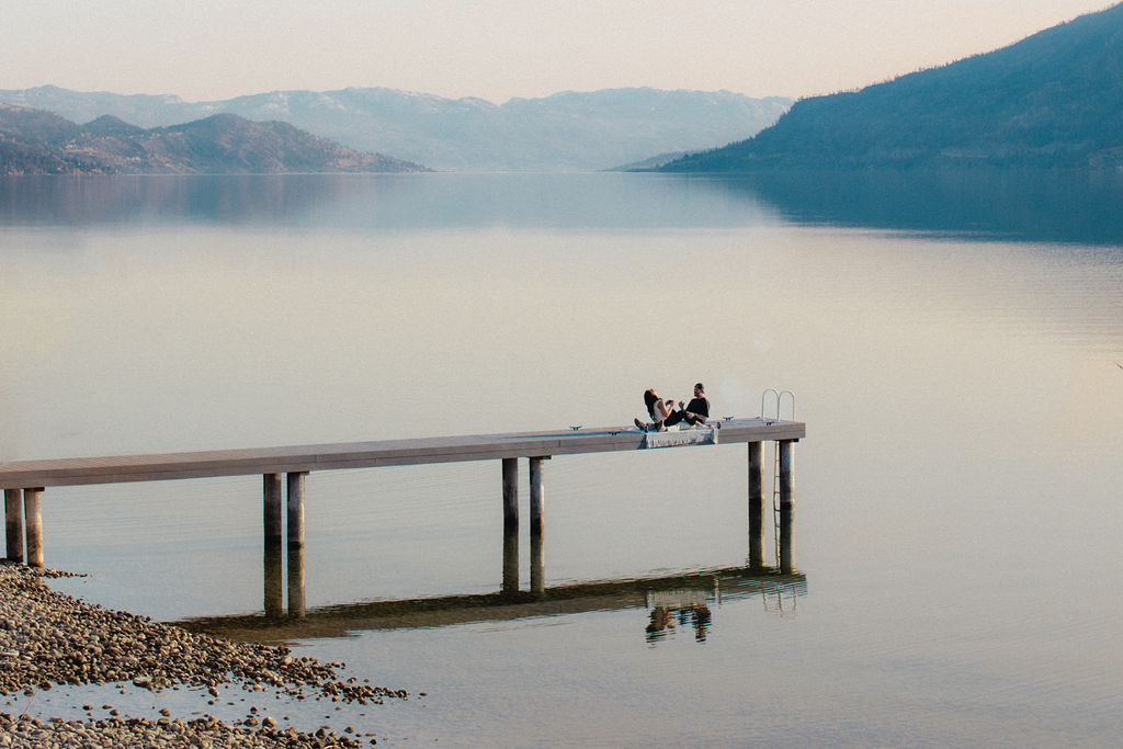 Kelowna engagement photographer session on a dock by the okanagan lake