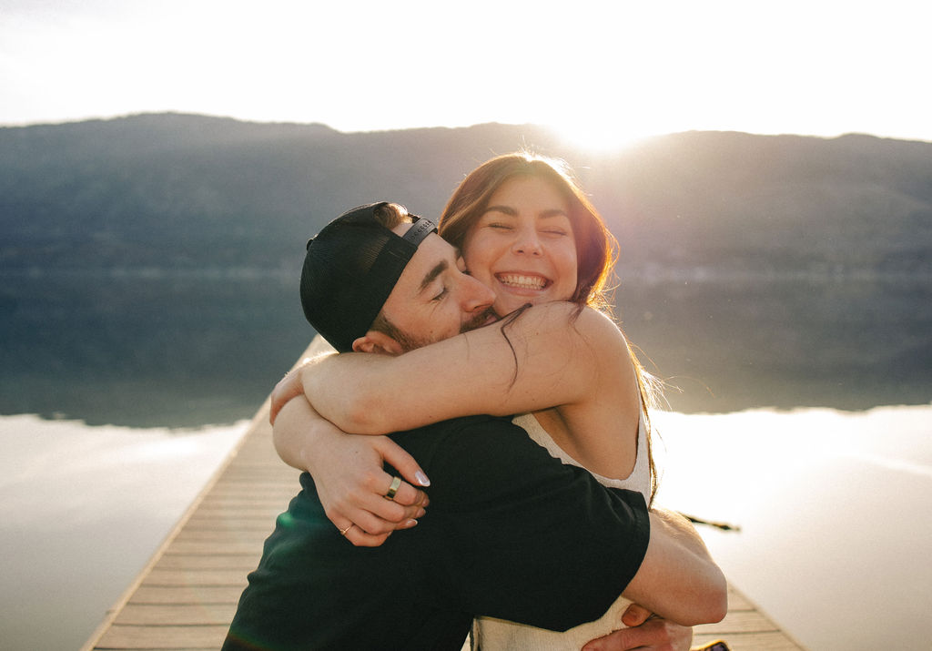 Kelowna engagement photographer session on a dock by the okanagan lake