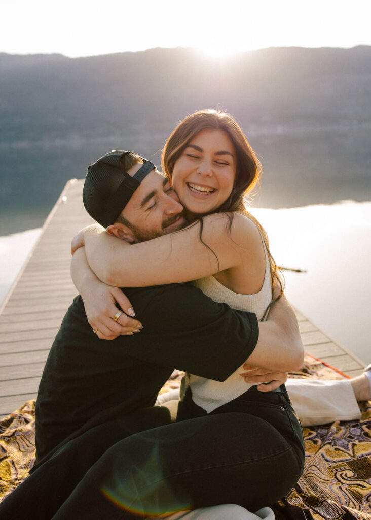 Kelowna engagement photographer session on a dock by the okanagan lake