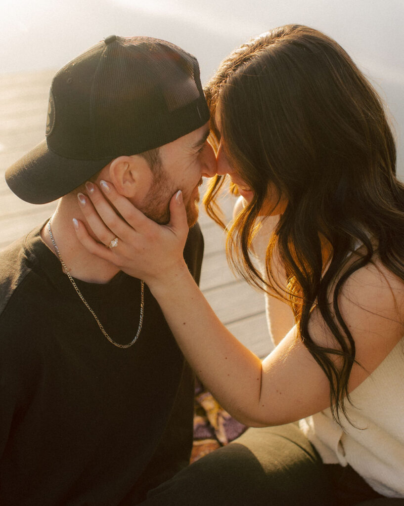 Kelowna engagement photographer session on a dock by the okanagan lake