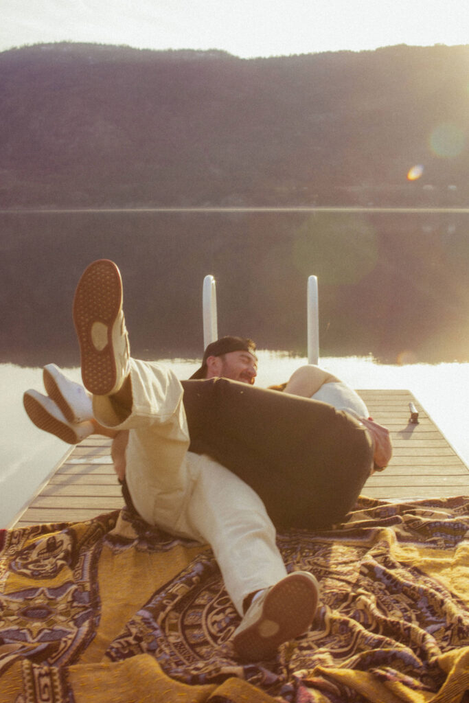 Kelowna engagement photographer session on a dock by the okanagan lake