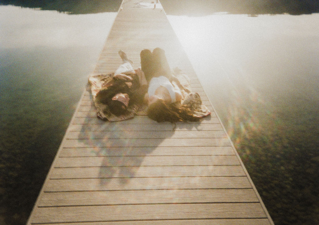 Kelowna engagement photographer session on a dock by the okanagan lake